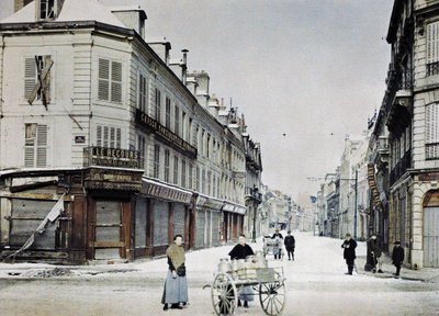 A woman with a cart filled with milk cans in Rue de Vesle and a man with another cart in Rue de Talleyrand behind her, Reims, France, March 3, 1917 by Paul Castelnau